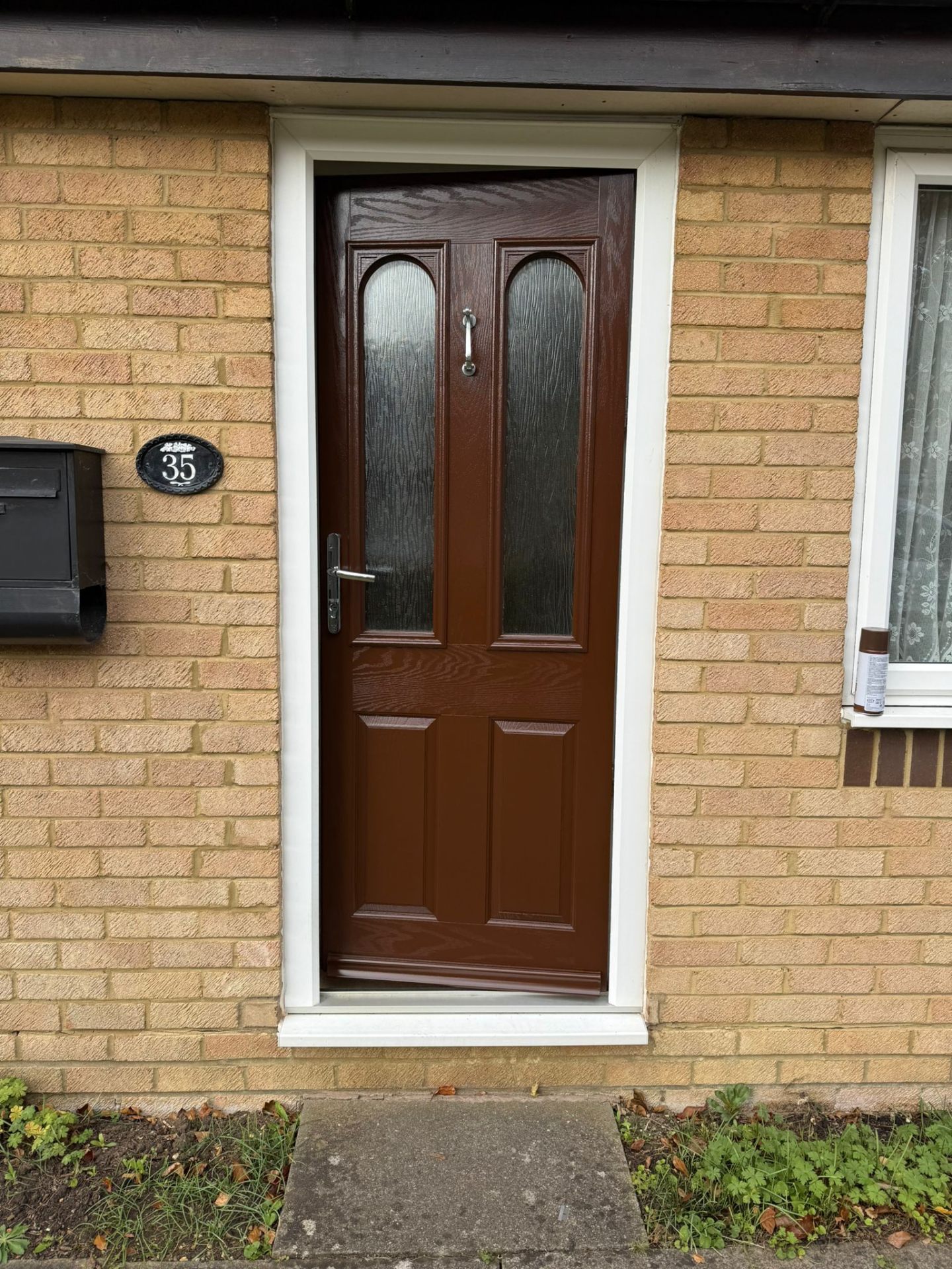 Brown front door with glass