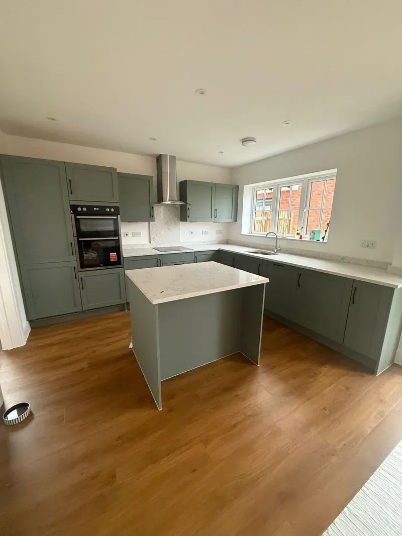 Sage green kitchen cabinet respray with island by Spray Genius in Lichfield