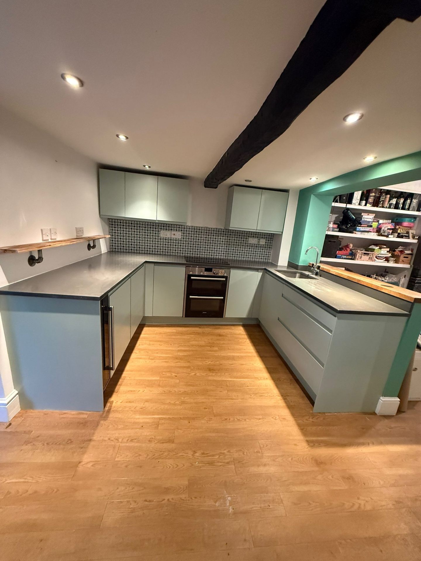 Mint green kitchen with exposed beams